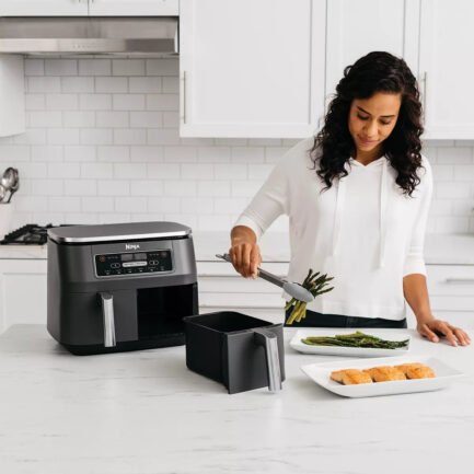 2 INDEPENDENT BASKETS: The original Air Fryer with 2 independent baskets, the XL air fryer lets you cook 2 foods, 2 ways, at the same time, eliminating back-to-back cooking like a traditional single-basket air fryer. SMART FINISH & MATCH COOK: DualZone Technology allows you to choose between the Smart Finish feature, which unlocks cooking 2 foods 2 ways that finish at the same time, and the and a Match Cook button to easily copy settings across zones for full 8-qt capacity. 6-IN-1 FUNCTIONALITY: Includes 6 versatile cooking programs: Air Fry, Air Broil, Roast, Bake, Reheat, and Dehydrate. The baskets can be washed in the dishwasher or by hand. XL CAPACITY: The 8-quart air fryer capacity lets you fit mains and sides at the same time for making quick family meals, or up to 4 lbs. of French fries or chicken wings. SEPARATE HEATING ZONES: 2 independent 4-quart zones have their own cooking baskets, cyclonic fans, and rapid heaters. EASY CLEANING: Easy-to-clean baskets and dishwasher-safe crisper plates. LESS FAT: Up to 75% less fat than traditional air frying methods. Tested against hand-cut, deep-fried French fries. - Image 3